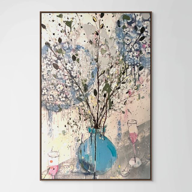 Hydrangeas in a blue vase and pink champagne